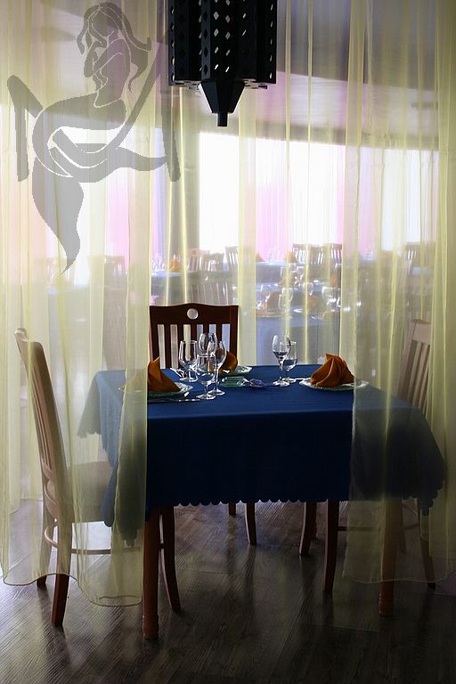 Table amid curtains